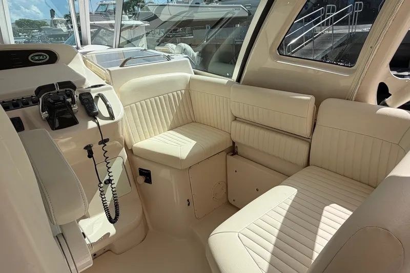Slide: The Image of Interior of 2009 Grady-White Express 360 boat with beige seating and control panel. - 7