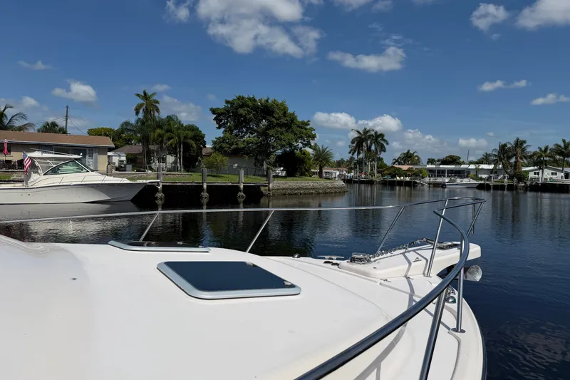 Slide: The Image of 2009 Grady-White Express 360 boat docked in a scenic canal with palm trees. - 2