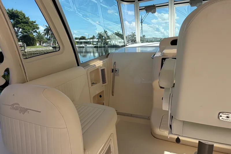 Slide: The Image of 2009 Grady-White Express 360 boat interior with cream seating and waterfront view. - 6