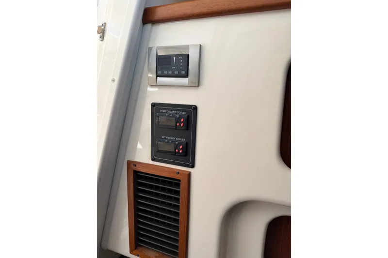 Slide: The Image of 2009 Grady-White Express 360 control panel with coolers and vent. - 23