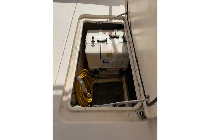 Slide: The Image of Storage compartment of 2009 Grady-White Express 360 boat with equipment and yellow cable. - 25