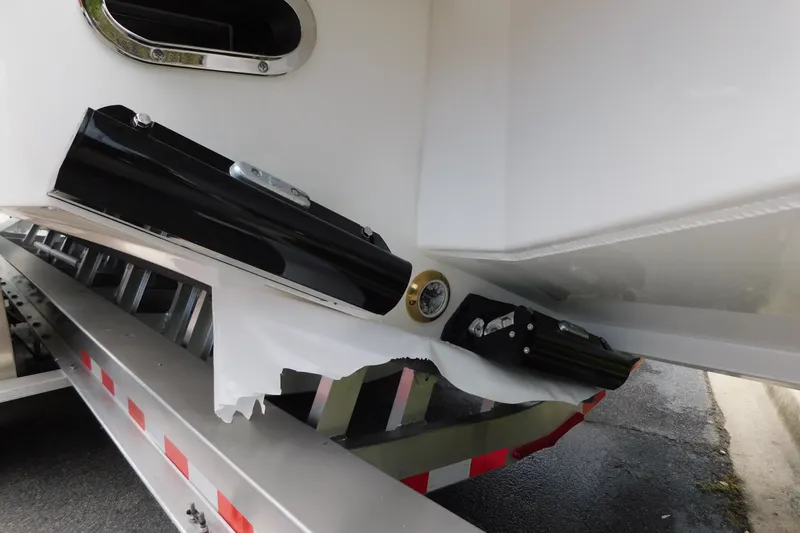 Slide: The Image of Damaged hull of a 2027 Regulator 35 boat on a trailer. - 63
