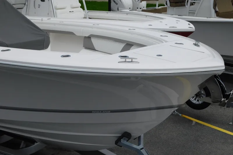 Slide: The Image of 2027 Regulator 35 boat displayed in a showroom, showcasing sleek design and modern features. - 32