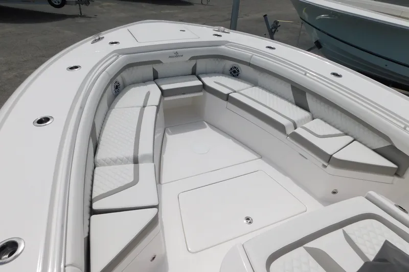 Slide: The Image of 2027 Regulator 35 boat interior with white cushioned seating and sleek design. - 8