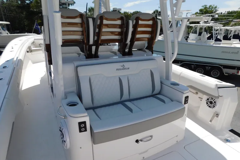 Slide: The Image of 2027 Regulator 35 boat interior with cushioned seating and cup holders. - 11