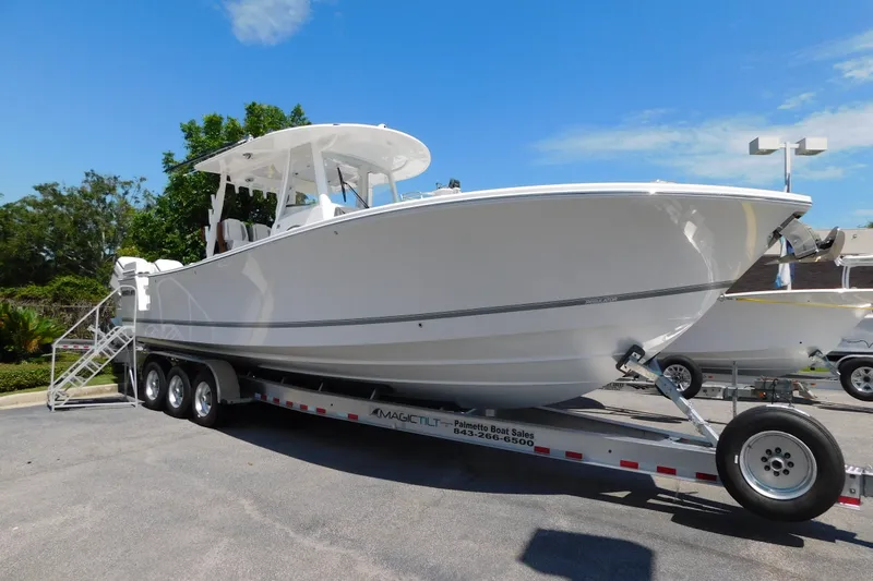 Slide: The Image of 2027 Regulator 35 boat on trailer under clear blue sky. - 1