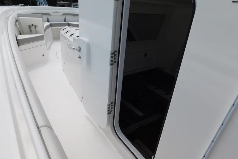 Slide: The Image of 2027 Regulator 35 boat interior, featuring sleek white design and spacious seating area. - 62