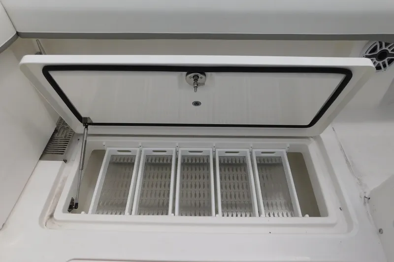 Slide: The Image of Open storage compartment on a 2027 Regulator 35 boat, featuring organized dividers. - 20