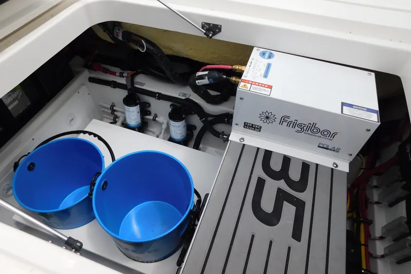 Slide: The Image of Interior of 2027 Regulator 35 boat with Frigibar refrigeration system and blue buckets. - 25