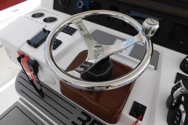 Slide: The Image of Steering wheel of a 2027 Regulator 35 boat with modern controls and accessories. - 3