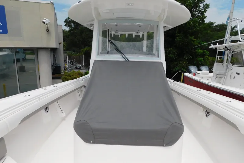 Slide: The Image of 2027 Regulator 35 boat with covered seating area, docked near other vessels. - 33