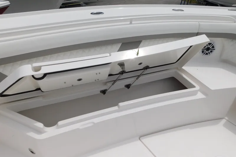 Slide: The Image of Open storage compartment on 2027 Regulator 35 boat, featuring sleek white interior design. - 36