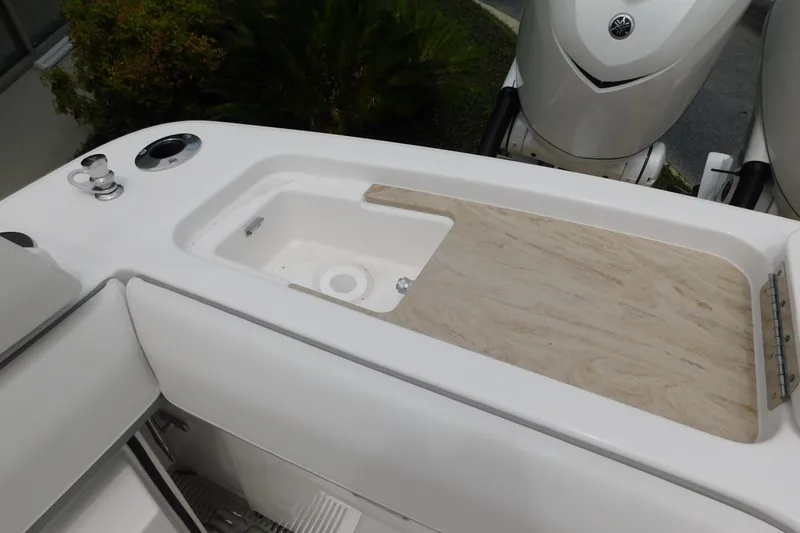 Slide: The Image of 2027 Regulator 35 boat deck with storage compartment and dual engines. - 16