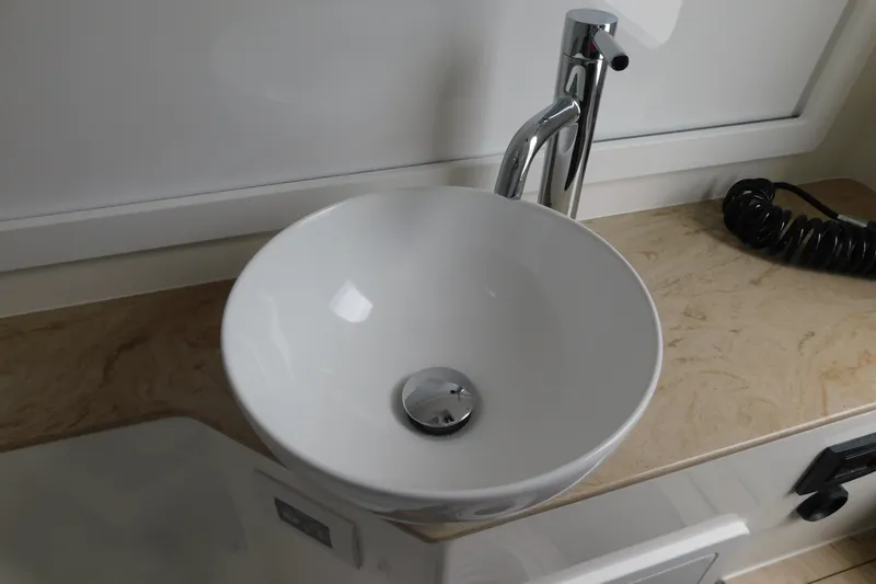 Slide: The Image of Modern bathroom sink with chrome faucet on marble countertop, Regulator 35, 2027 model. - 58