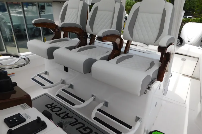 Slide: The Image of Luxury seating on 2027 Regulator 35 boat with white and gray upholstery. - 5