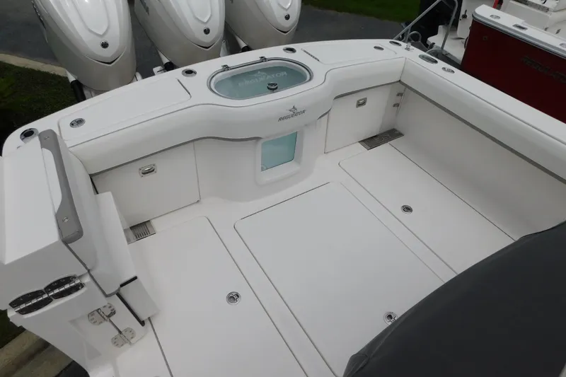 Slide: The Image of 2027 Regulator 35 boat deck with outboard engines and storage compartments. - 13