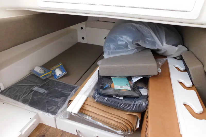 Slide: The Image of Interior storage area of a 2027 Regulator 35 boat with various items and packaging. - 59