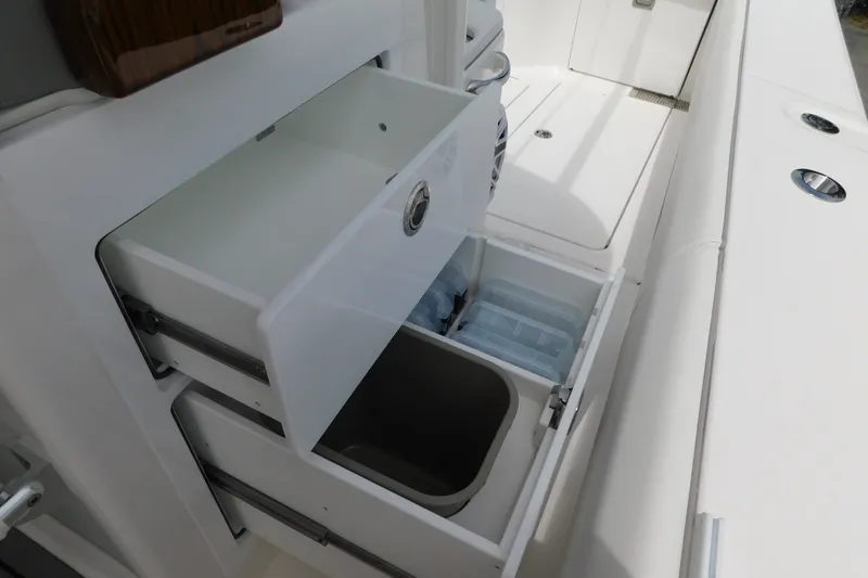 Slide: The Image of 2027 Regulator 35 boat interior storage compartments with open drawers and bins. - 43