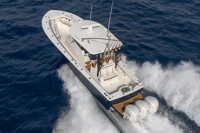 Slide: The Image of Manufacturer Provided Image: 2026 Regulator 35 boat cruising on open ocean with triple outboard engines. - 77