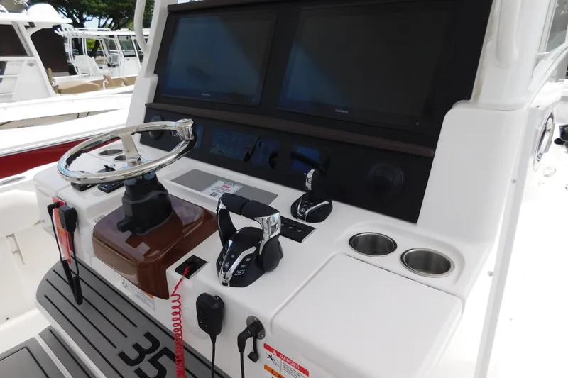 Slide: The Image of Helm of 2027 Regulator 35 boat with dual screens and modern controls. - 7