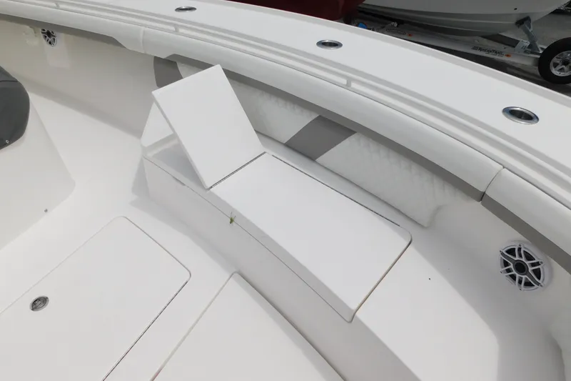 Slide: The Image of 2027 Regulator 35 boat interior with white seating and storage compartments. - 35