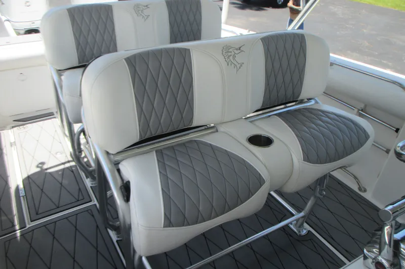 Slide: The Image of 2007 Marlago FS 35 Cuddy boat seats with gray and white diamond-pattern upholstery. - 15