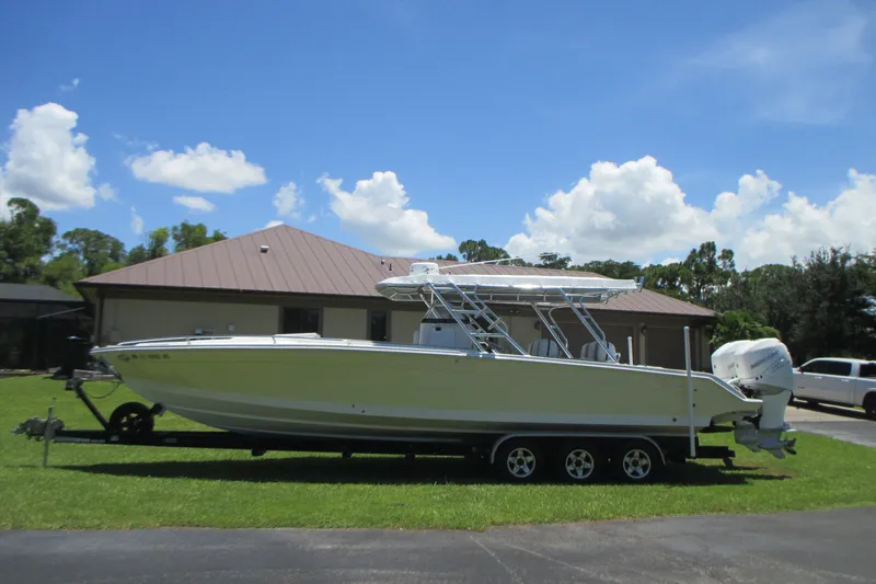 Slide: The Image of 2007 Marlago FS 35 Cuddy boat on trailer, parked in front of a house. - 2