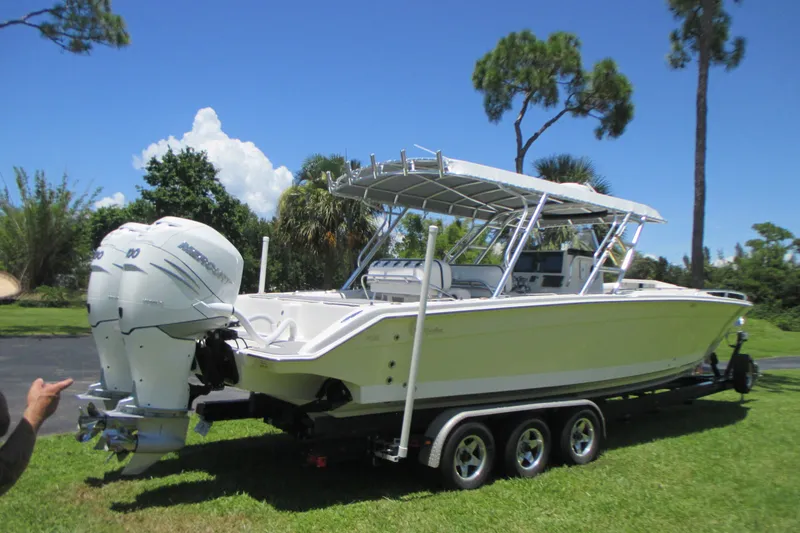 Slide: The Image of 2007 Marlago FS 35 Cuddy boat on trailer, featuring twin Mercury outboard engines. - 5