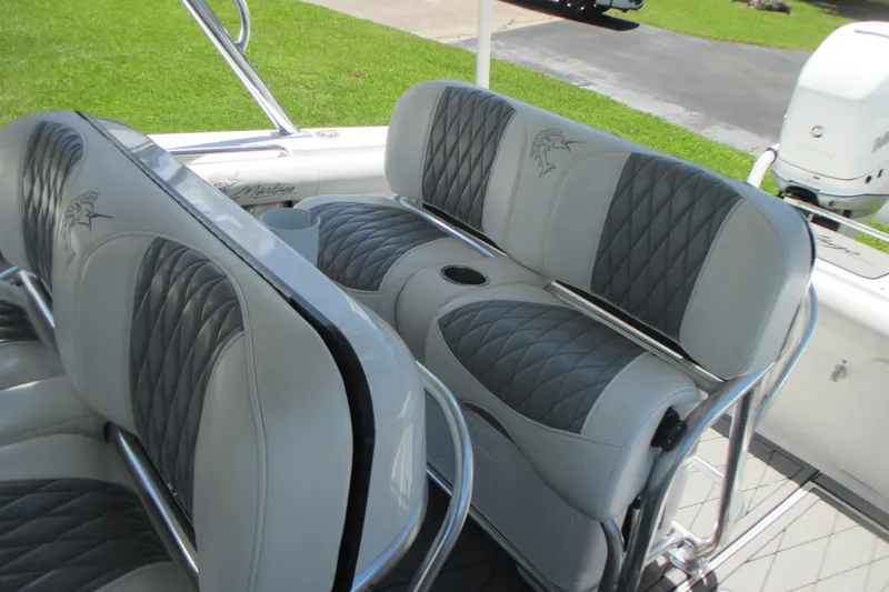 Slide: The Image of 2007 Marlago FS 35 Cuddy boat seats with diamond-pattern upholstery and cup holders. - 16