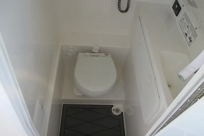 Slide: The Image of 2007 Marlago FS 35 Cuddy boat bathroom interior with toilet and sink. - 18