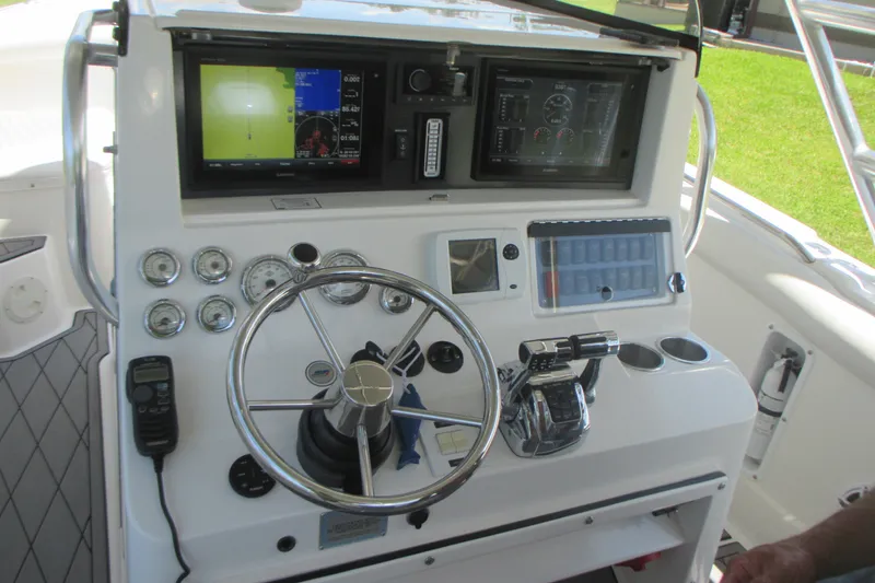 Slide: The Image of 2007 Marlago FS 35 Cuddy helm with steering wheel, gauges, and navigation screens. - 13