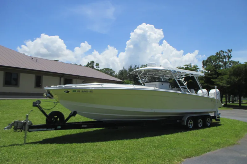 Slide: The Image of 2007 Marlago FS 35 Cuddy boat on trailer, parked on grass under blue sky. - 3