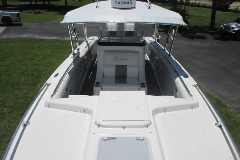 Slide: The Image of 2007 Marlago FS 35 Cuddy boat with Garmin equipment, docked on grass. - 25