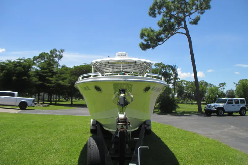 Slide: The Image of 2007 Marlago FS 35 Cuddy boat on trailer, parked on grass under clear blue sky. - 1