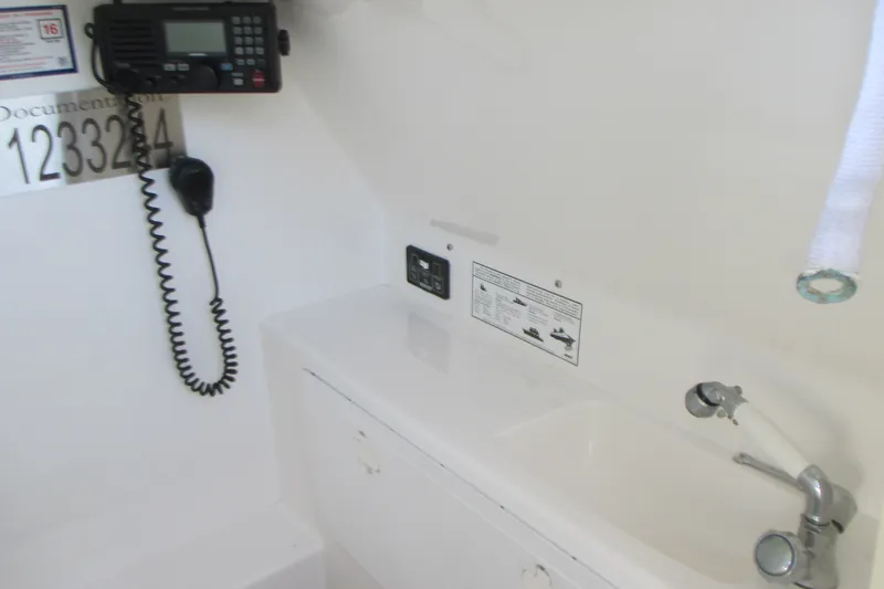 Slide: The Image of 2007 Marlago FS 35 Cuddy interior with radio and sink setup. - 19