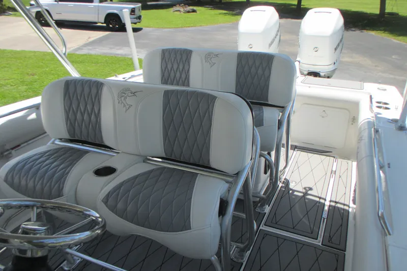 Slide: The Image of 2007 Marlago FS 35 Cuddy boat interior with cushioned seating and dual outboard motors. - 14