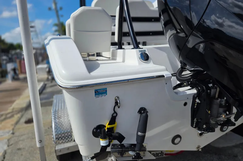 Slide: The Image of 2025 Sea Pro 225FLX Sandbar boat rear view with motor and dock details. - 24