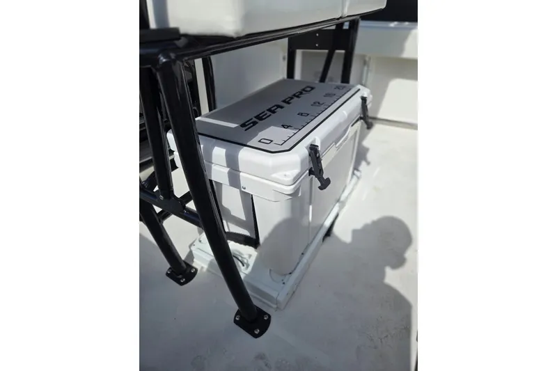 Slide: The Image of 2025 Sea Pro 225FLX Sandbar boat cooler with measuring scale on deck. - 23