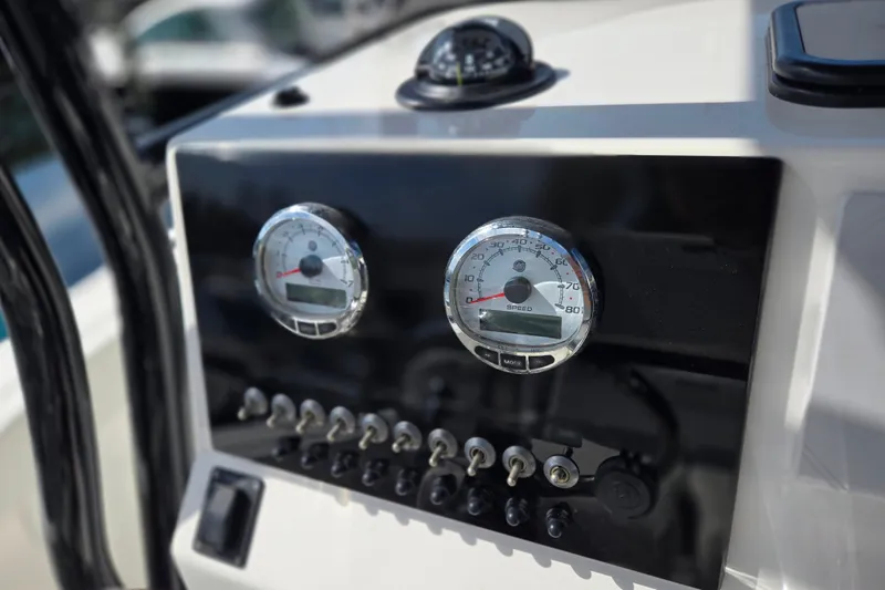 Slide: The Image of Dashboard of 2025 Sea Pro 225FLX Sandbar boat with gauges and switches. - 16