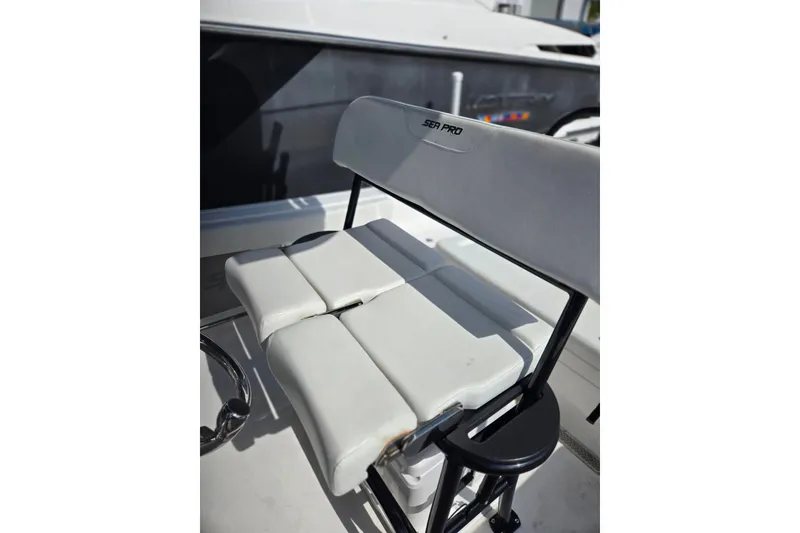 Slide: The Image of 2025 Sea Pro 225FLX Sandbar boat seat with white cushioned design. - 13