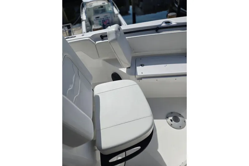 Slide: The Image of 2025 Sea Pro 225FLX Sandbar boat interior with white seating and storage compartment. - 20