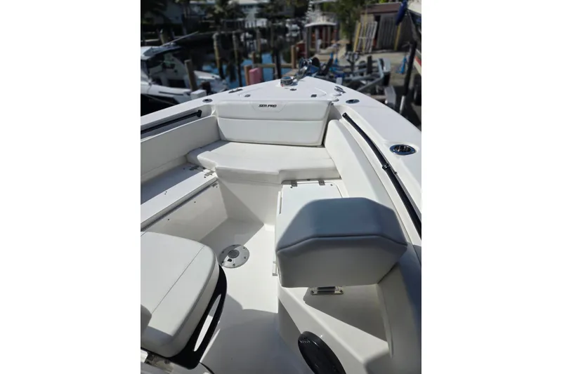 Slide: The Image of 2025 Sea Pro 225FLX Sandbar boat interior with white seating and sleek design. - 19