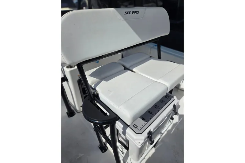 Slide: The Image of 2025 Sea Pro 225FLX Sandbar boat seating with integrated cooler and measuring scale. - 14