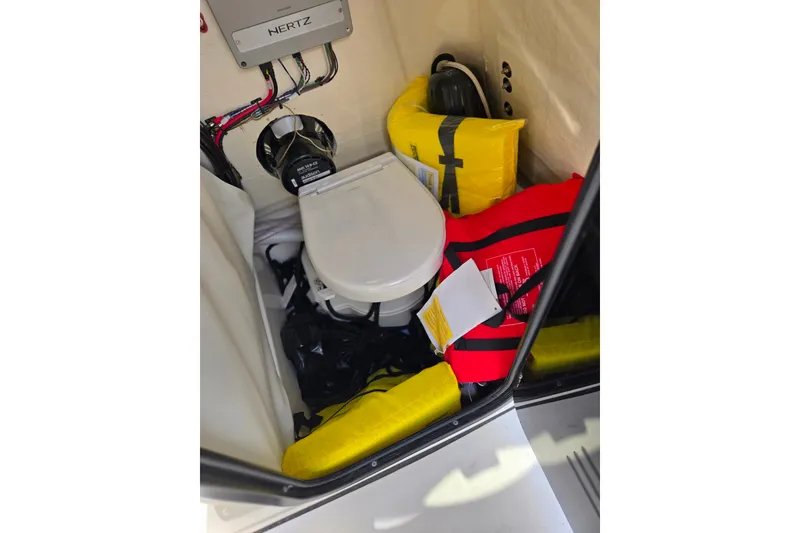 Slide: The Image of 2025 Sea Pro 225FLX Sandbar boat interior with life jackets and marine toilet. - 17
