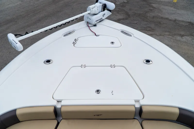 Slide: The Image of 2021 Tidewater 2300 Carolina Bay boat deck with trolling motor and storage compartments. - 21