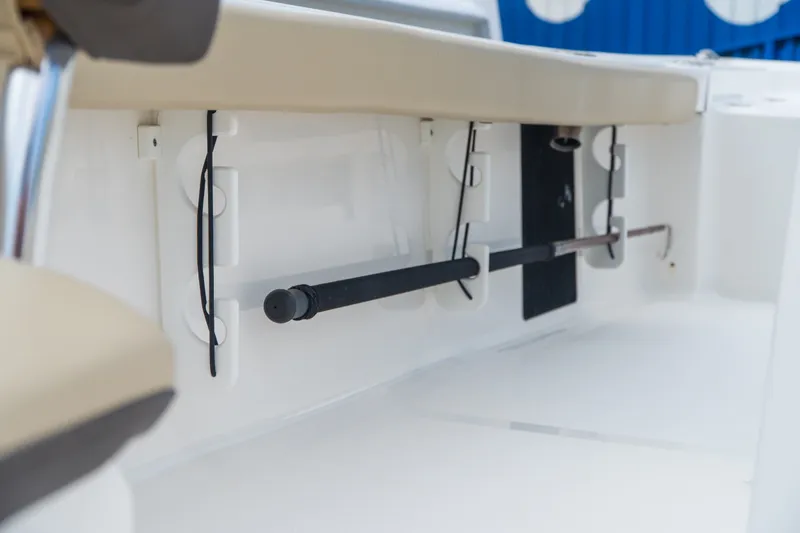 Slide: The Image of 2021 Tidewater 2300 Carolina Bay boat interior with rod holders and beige seating. - 28
