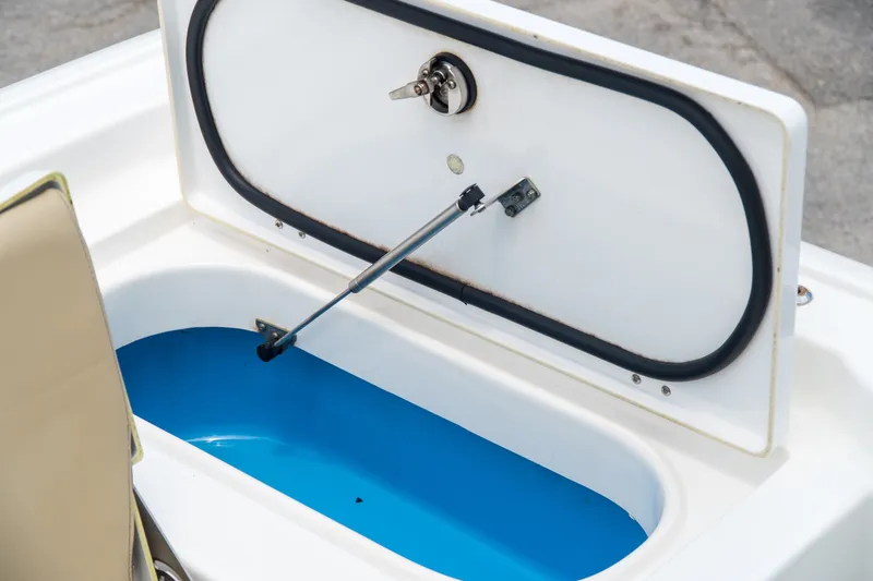 Slide: The Image of Open storage compartment on 2021 Tidewater 2300 Carolina Bay boat, featuring blue interior. - 42