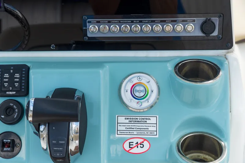 Slide: The Image of Control panel of a 2021 Tidewater 2300 Carolina Bay boat with various switches and labels. - 19