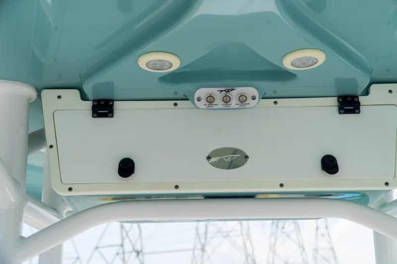 Slide: The Image of Tidewater 2300 Carolina Bay 2021 boat console with switches and lights. - 32