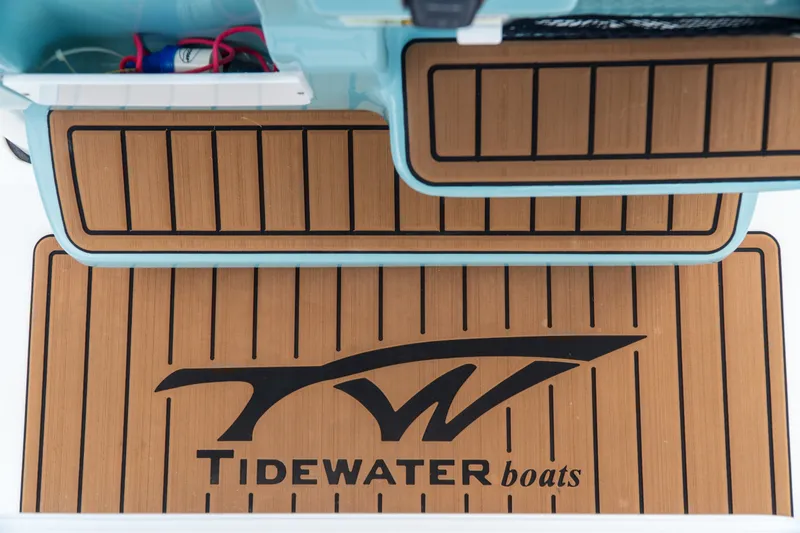 Slide: The Image of 2021 Tidewater 2300 Carolina Bay boat deck with logo and teak-style flooring. - 36